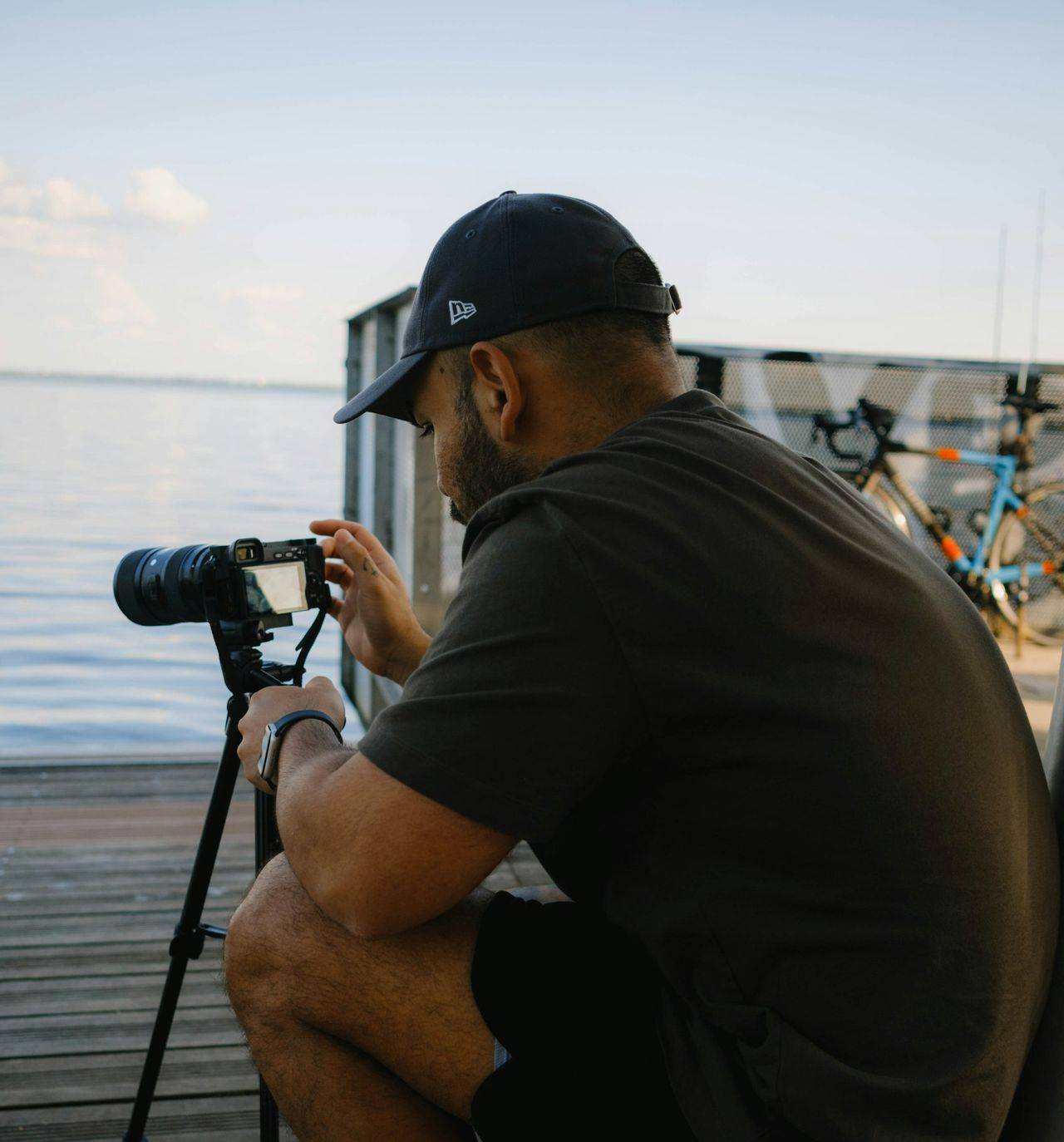 a man sitting on a dock with a camera